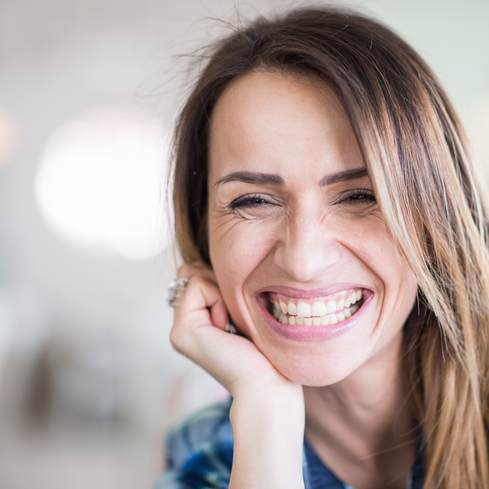 Portrait of cheerful smiling woman, toned image
