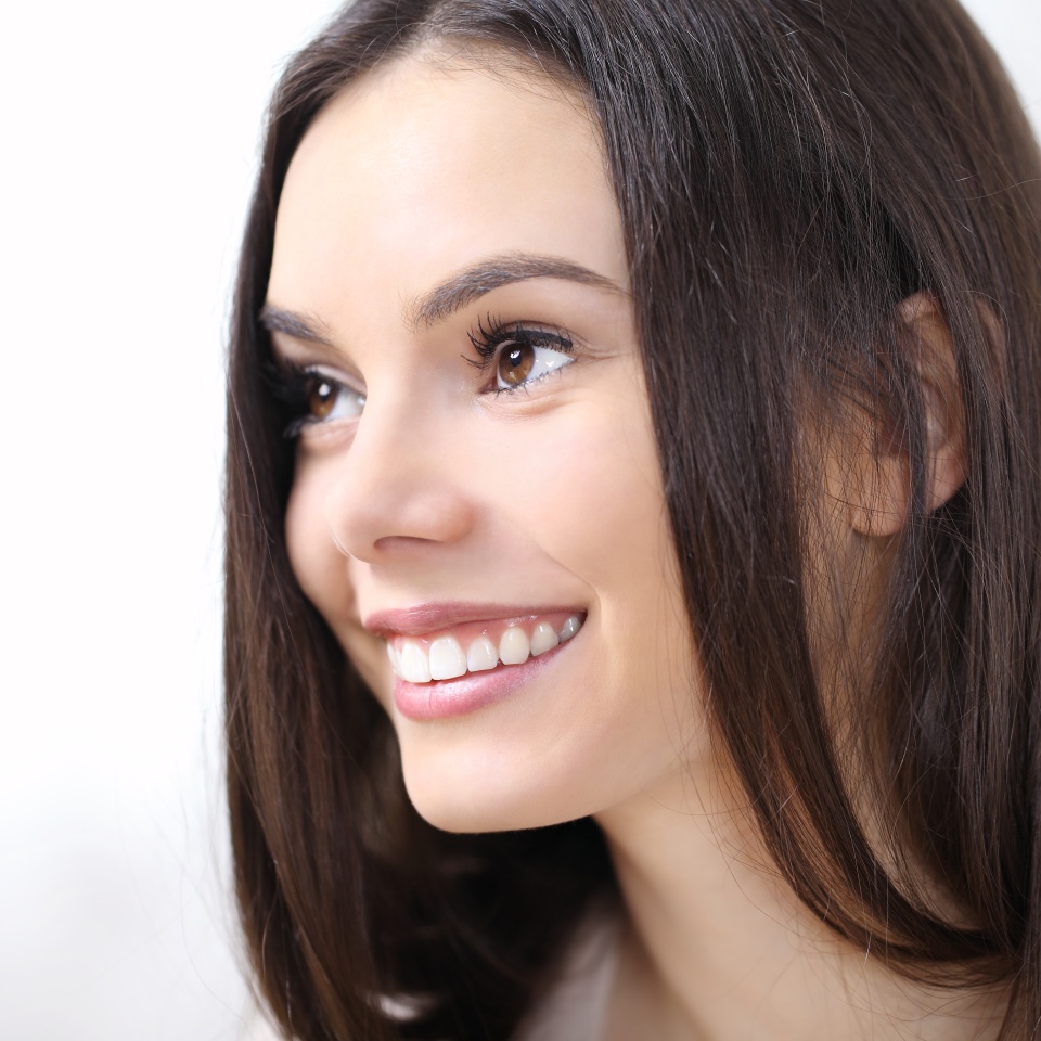 smiling woman portrait in profile looking isolated on white