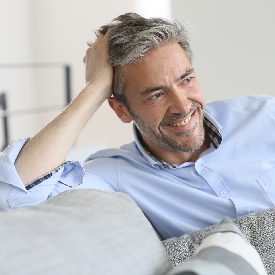 Smiling handsome 45-year-old man relaxing at home
