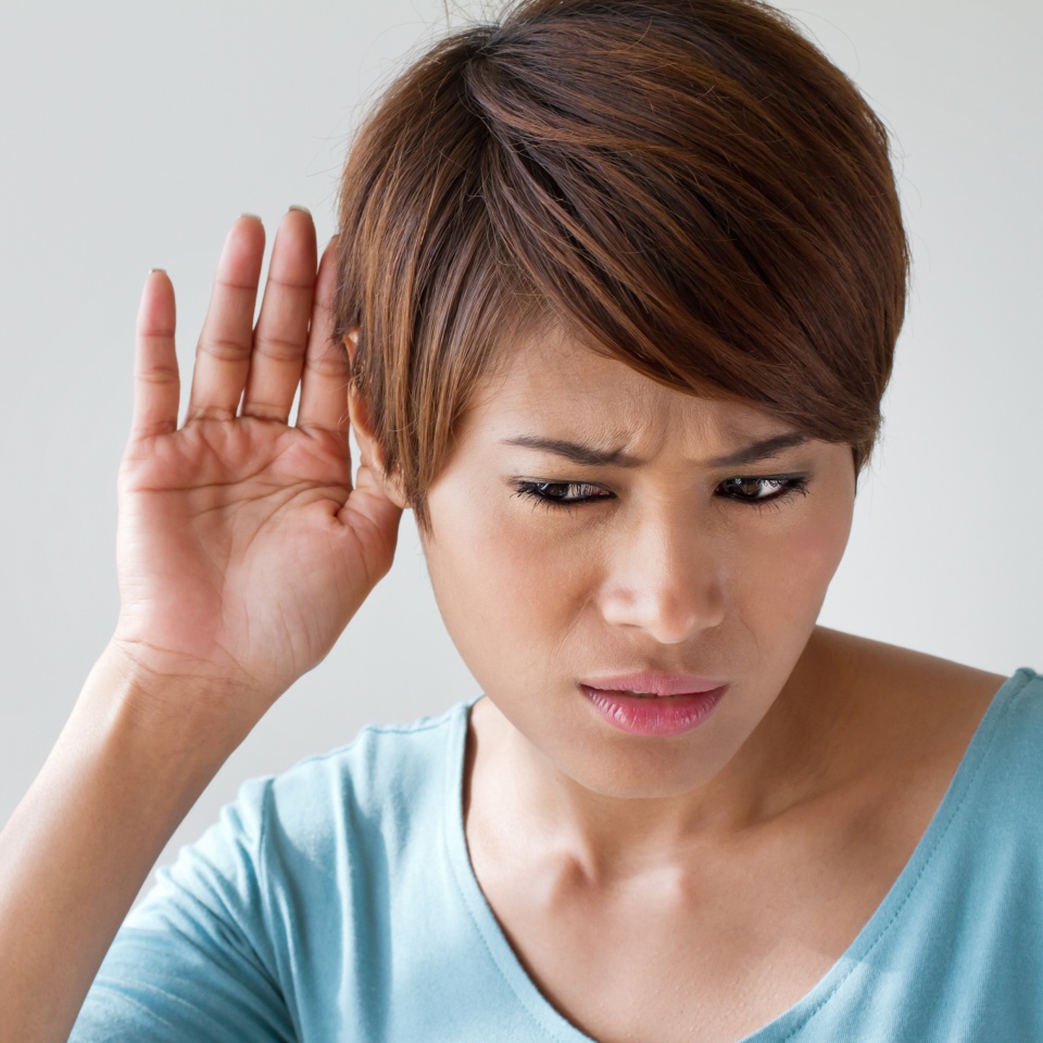 woman suffers from hearing impairment, hard of hearing, hearing loss, acoustic or ear problem, deafness with text space