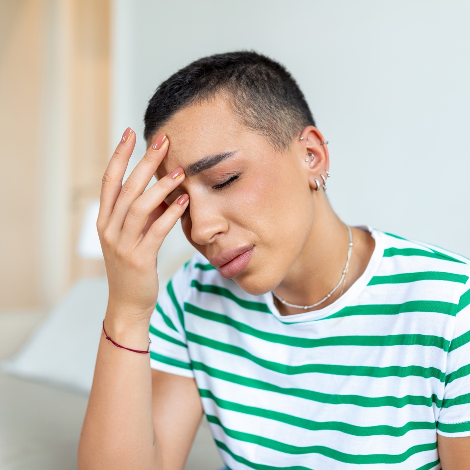 Sinus ache causing very paintful headache. Unhealthy woman in pain. Sharp strong sore. Sinus pain, sinus pressure, sinusitis. Sad woman holding her head because sinus pain