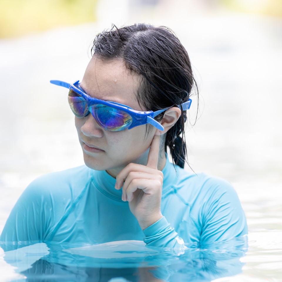 Stressed asian girl had tinnitus,problem with water entering the ear canal while swimming,female people cleaning ears after diving in swimming pool,otitis externa,swimmer's ear,health care concept